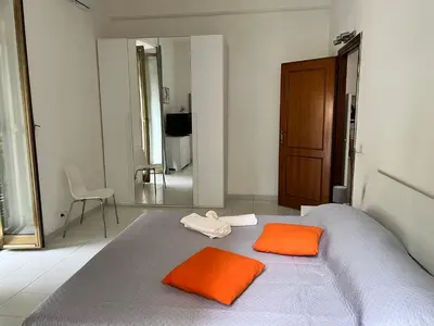 a bedroom with a bed with two orange pillows on it at Home Rome in Rome