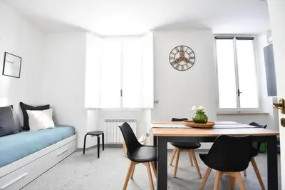 a living room with a table and chairs and a couch at Maison Margaret in Rome
