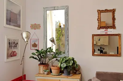 a room with a mirror and plants on a table at Cozy Esquilino - My Extra Home in Rome