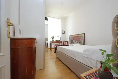 a bedroom with a bed and a dresser and a table at Cozy Esquilino - My Extra Home in Rome