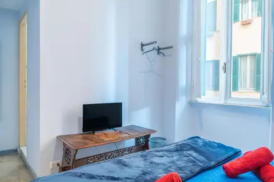 a bedroom with a bed and a tv on a table at Lion Renting Metro Piramide in Rome