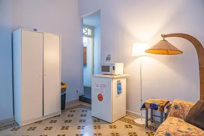 a living room with a couch and a microwave at Lion Renting Metro Piramide in Rome