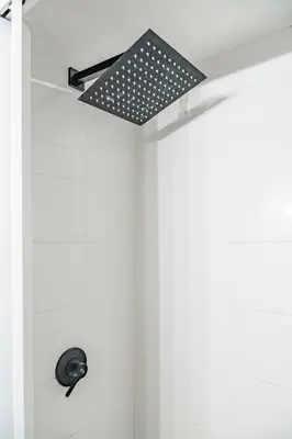 a bathroom with a shower with a light on the ceiling at Lion Renting Metro Piramide in Rome