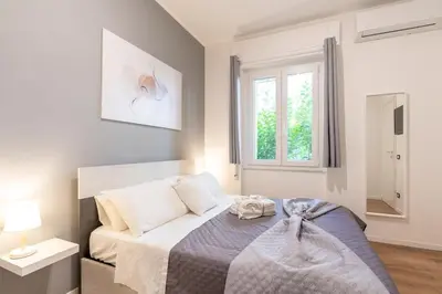 a bedroom with a bed and a window at Central Modern Apartment - Colosseo 10 min in Rome