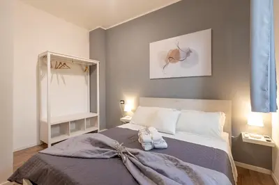 a bedroom with a bed with a towel on it at Central Modern Apartment - Colosseo 10 min in Rome