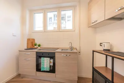 a small kitchen with a sink and a stove at Central Modern Apartment - Colosseo 10 min in Rome