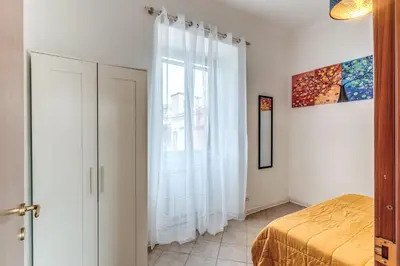 a bedroom with a bed and a large window at Pìgneto Roma Good Vibes Apartment in Rome