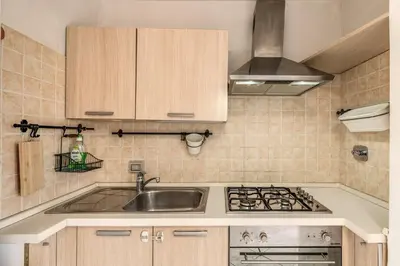 a kitchen with a sink and a stove at Pìgneto Roma Good Vibes Apartment in Rome