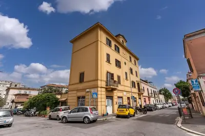 a yellow building on the side of a street at Pìgneto Roma Good Vibes Apartment in Rome