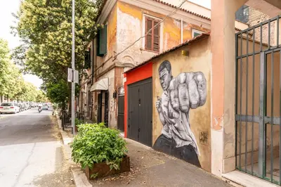 a mural of a hand painted on the side of a building at Pìgneto Roma Good Vibes Apartment in Rome