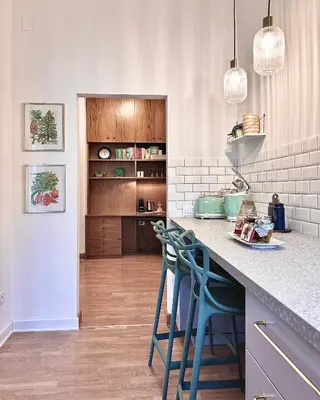a kitchen with a counter and blue stools at Flaminio Blues, Cozy Flat Near Piazza del Popolo in Rome