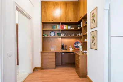 a home office with a desk and shelves at Flaminio Blues, Cozy Flat Near Piazza del Popolo in Rome