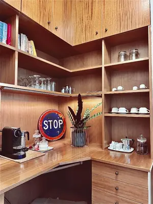 a kitchen with wooden cabinets and a stop sign at Flaminio Blues, Cozy Flat Near Piazza del Popolo in Rome