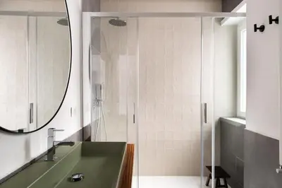 a bathroom with a green sink and a shower at Vatican Loft - Musei Vaticani in Rome
