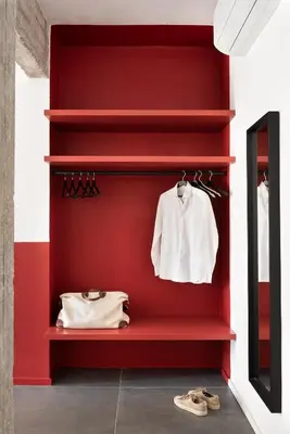 a red wall with a white shirt and shoes at Vatican Loft - Musei Vaticani in Rome