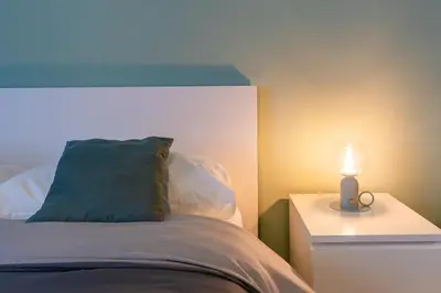 a bedroom with a bed with a lamp on a night stand at Monteverde 65 in Rome