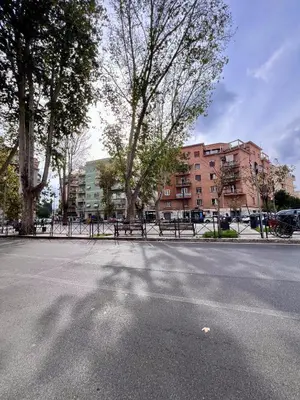 a street with benches and buildings in a city at Monteverde 65 in Rome