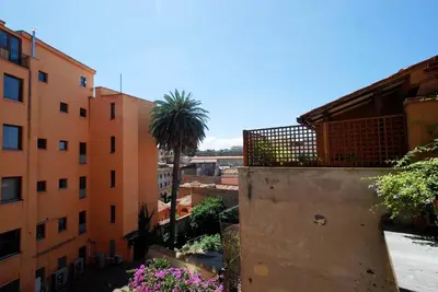 a view of a city with a palm tree and buildings at Piazza di Spagna Suite in Rome