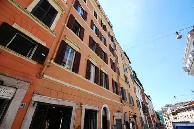 a large orange brick building on a city street at Piazza di Spagna Suite in Rome