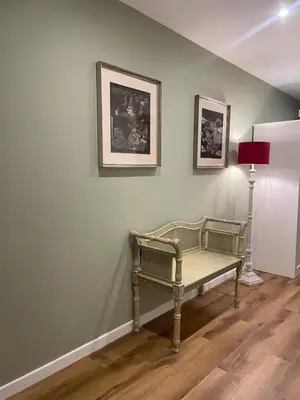 a bench in a room with two pictures on the wall at Maison Adelaide in Rome