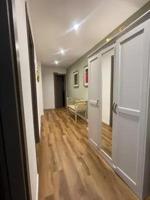 a hallway with two doors and a wooden floor at Maison Adelaide in Rome