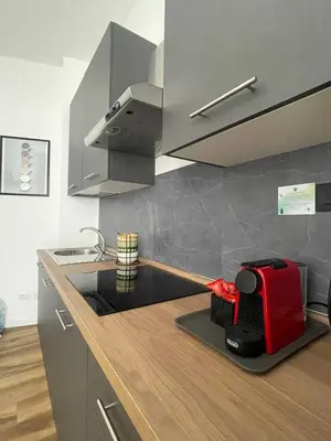 a kitchen with a red toaster on a counter at Maison Adelaide in Rome