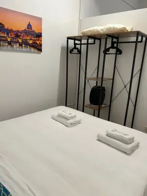 a bedroom with a bed with towels on it at Lovely apartment in the center of Rome, Monti in Rome