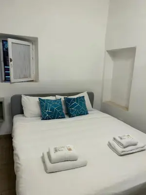 a white bed with two towels on top of it at Lovely apartment in the center of Rome, Monti in Rome