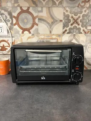 a toaster oven sitting on the floor next to a wall at Lovely apartment in the center of Rome, Monti in Rome