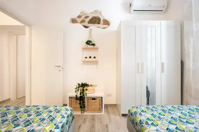 a bedroom with two beds and a table with plants at Design Flat - Nel Centro di Roma in Rome