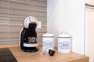 a coffee maker and two cups on a counter at Design Flat - Nel Centro di Roma in Rome