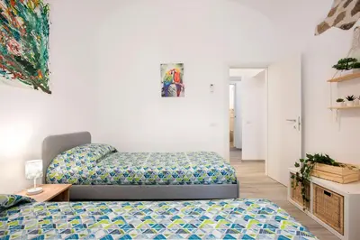 a bedroom with a bed and a couch at Design Flat - Nel Centro di Roma in Rome