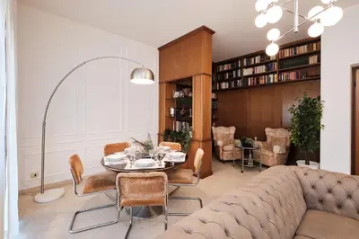 a living room with a couch and a table and chairs at Elegante appartamento con 3 Camere da letto vicino il Centro in Rome