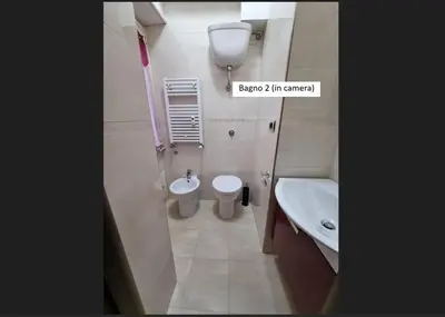 a small bathroom with a toilet and a sink at Sweet Holiday Gardenie in Rome