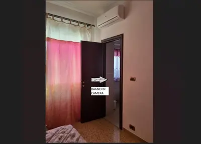 a room with a door with a sign on it at Sweet Holiday Gardenie in Rome