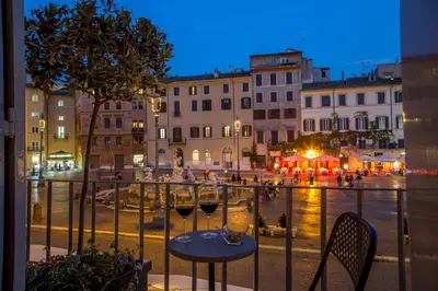 a balcony with a table and two glasses of wine at Palazzo De Cupis - Suites and View in Rome