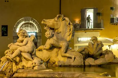 a statue in a fountain in a building at Palazzo De Cupis - Suites and View in Rome