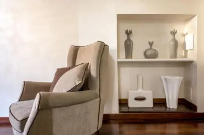 a room with two chairs and vases on a shelf at Palazzo De Cupis - Suites and View in Rome