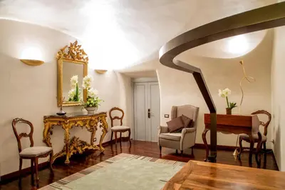 a living room with a piano and a chair at Palazzo De Cupis - Suites and View in Rome