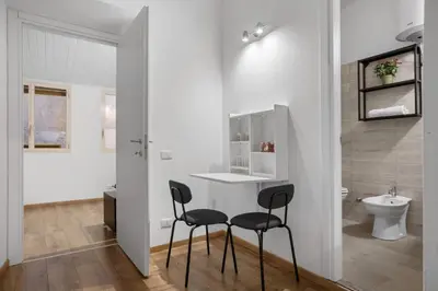 a bathroom with two chairs and a sink and a toilet at Cavour 172 - Monti Apartment near Colosseum by RHR in Rome