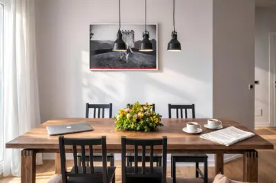 a dining room table with chairs and a laptop on it at Sunny Monteverde Apartment - Near Trastevere by RHR in Rome