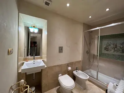 a bathroom with a toilet and a sink and a shower at Domus Minervae in Rome