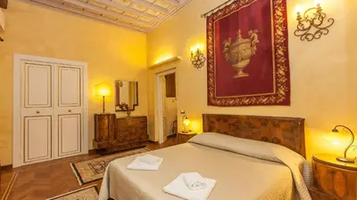 a bedroom with a bed and a picture on the wall at Domus Minervae in Rome