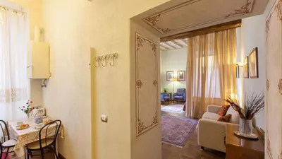 a living room with a table and a room with a living room at Domus Minervae in Rome