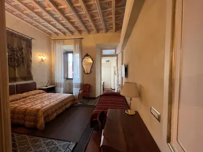 a hotel room with a bed and a table at Domus Minervae in Rome