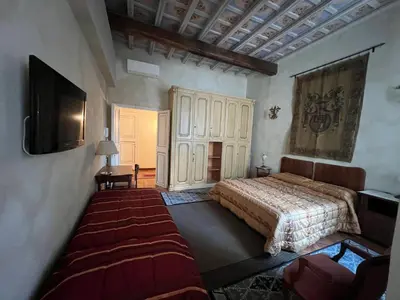 a bedroom with a bed and a television in it at Domus Minervae in Rome