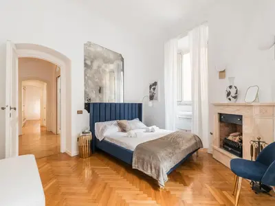 a bedroom with a bed and a fireplace at The Best Rent - Splendid three-bedroom apartment near the Trevi Fountain in Rome