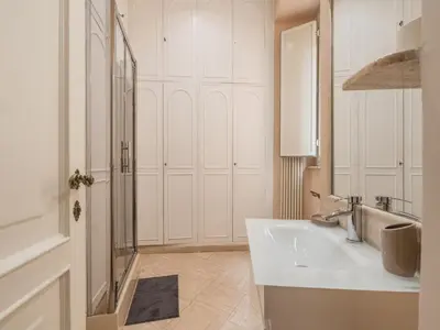 a white bathroom with a sink and a shower at The Best Rent - Splendid three-bedroom apartment near the Trevi Fountain in Rome