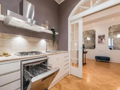 a kitchen with a stove and a sink at The Best Rent - Splendid three-bedroom apartment near the Trevi Fountain in Rome
