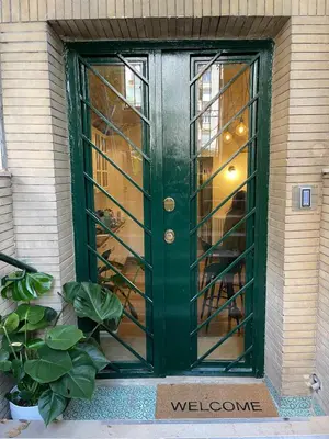 a green door with glass windows on a building at Giorgina Garden&Rooms in Rome